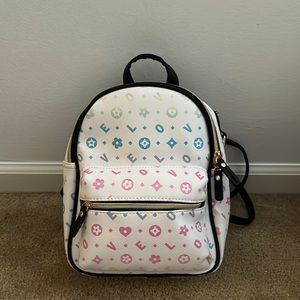 Mini kids backpack that says love on it